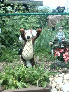 stuffed animal trying to climb over fence