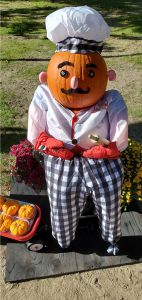 picture of a pumpkin baker wearing a white chef hat and plaid trousers