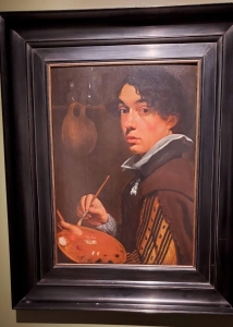 image of a male painter painting in a black frame