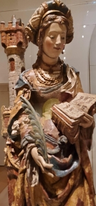 carving or statue of a woman reading a book